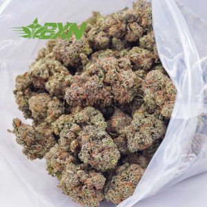 A bag of marijuana placed on a white surface.